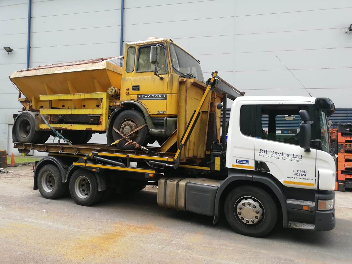 RR Davies Ltd lorry carrying a scrapped gritter truck